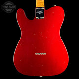 Red electric guitar body with Fender logo on a black background