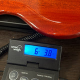 Used 2019 Gibson SG Junior Cherry on scale displaying weight.