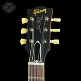Gibson Les Paul guitar headstock with brand name on a black background