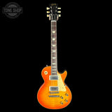 Orange electric guitar on a black background with 'Tone Shop' logo.