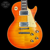 Orange electric guitar with a black background