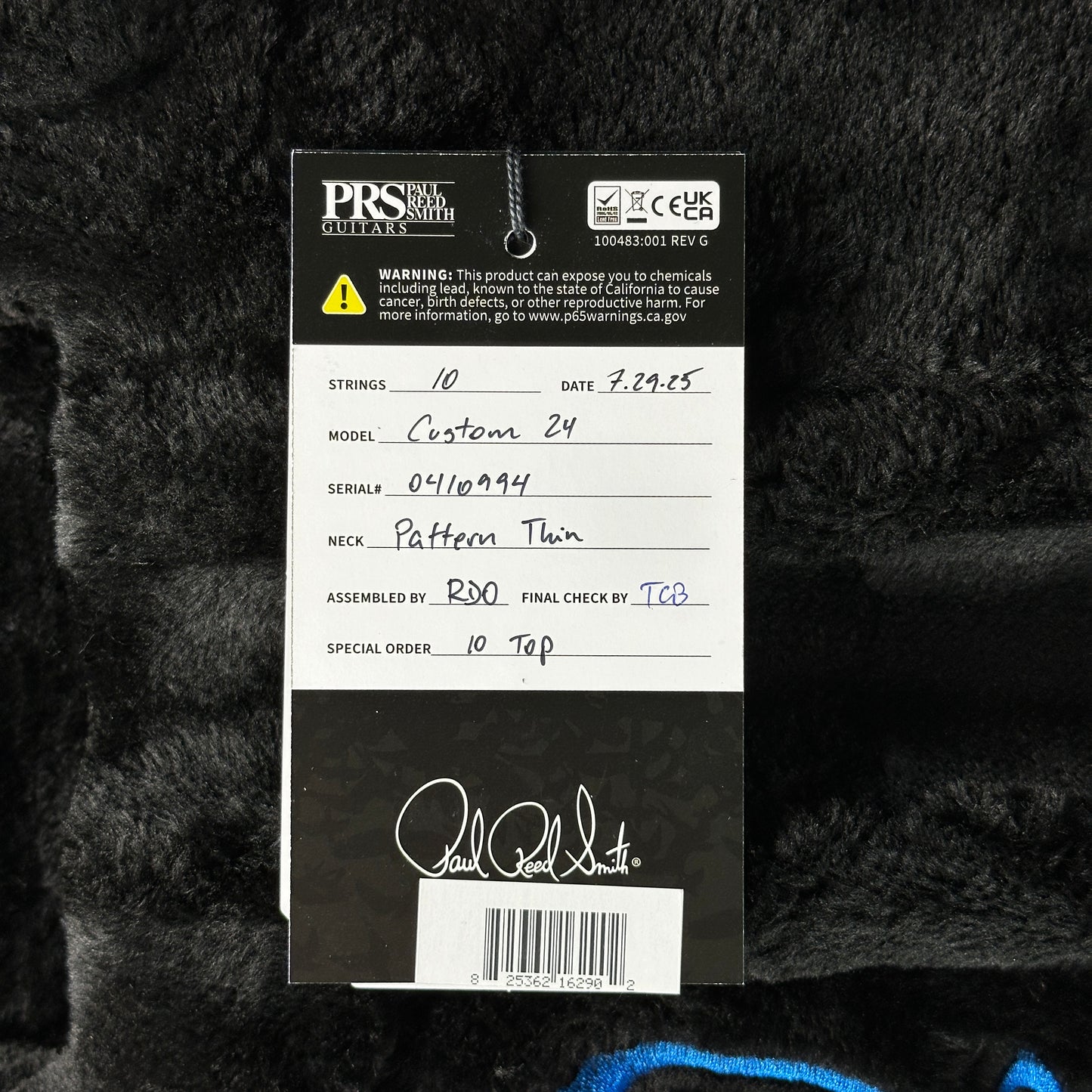 PRS guitar label with product details on a textured black background