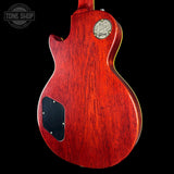 Red electric guitar body with Gibson logo on a black background