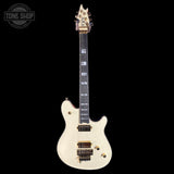 White electric guitar with gold hardware on a black background, featuring the Tone Shop logo.