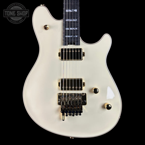 White electric guitar with gold hardware on a black background, featuring 'Tone Shop' logo.
