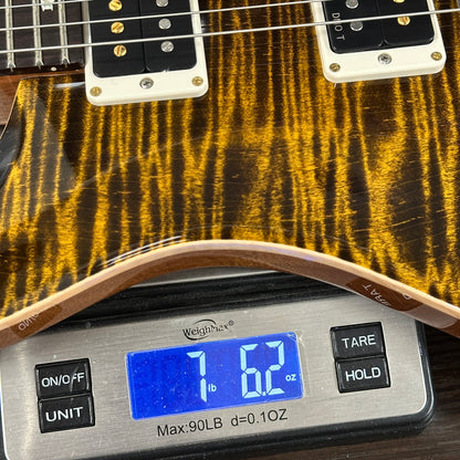 Guitar on a digital scale displaying weight