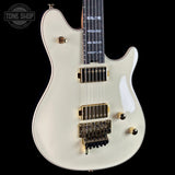 White electric guitar with gold hardware on a black background, featuring 'Tone Shop' branding.