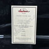 Jackson Custom Shop certificate on a guitar neck with a black background