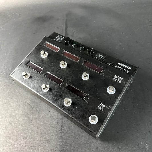 Black HX Effects guitar effects pedal on a gray surface