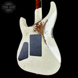 Worn electric guitar body with visible wear and tear on a black background, featuring 'Tone Shop' logo.
