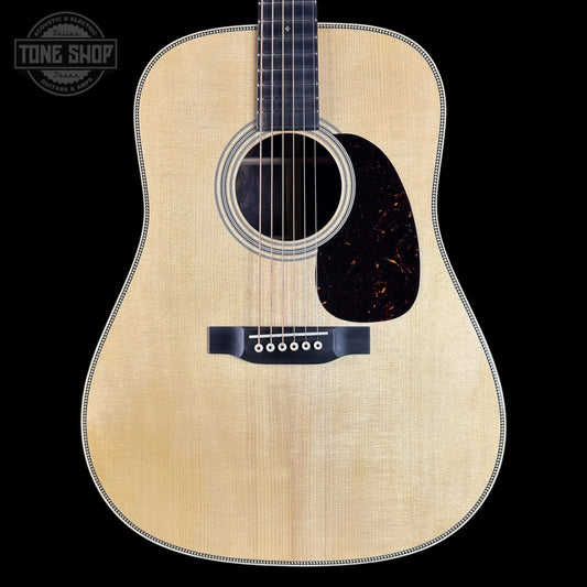 Acoustic guitar with a visible brand logo on a black background