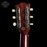 Gibson guitar headstock with brand logo on a black background