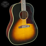 Acoustic guitar with a sunburst finish on a black background, featuring the Tone Shop logo.