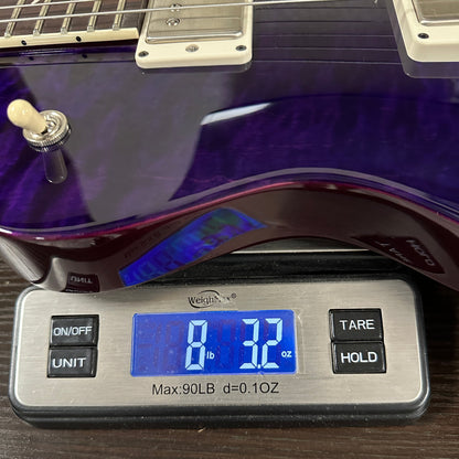 PRS S2 Wood Library McCarty 594 Singlecut Quilt Purple on scale displaying weight.