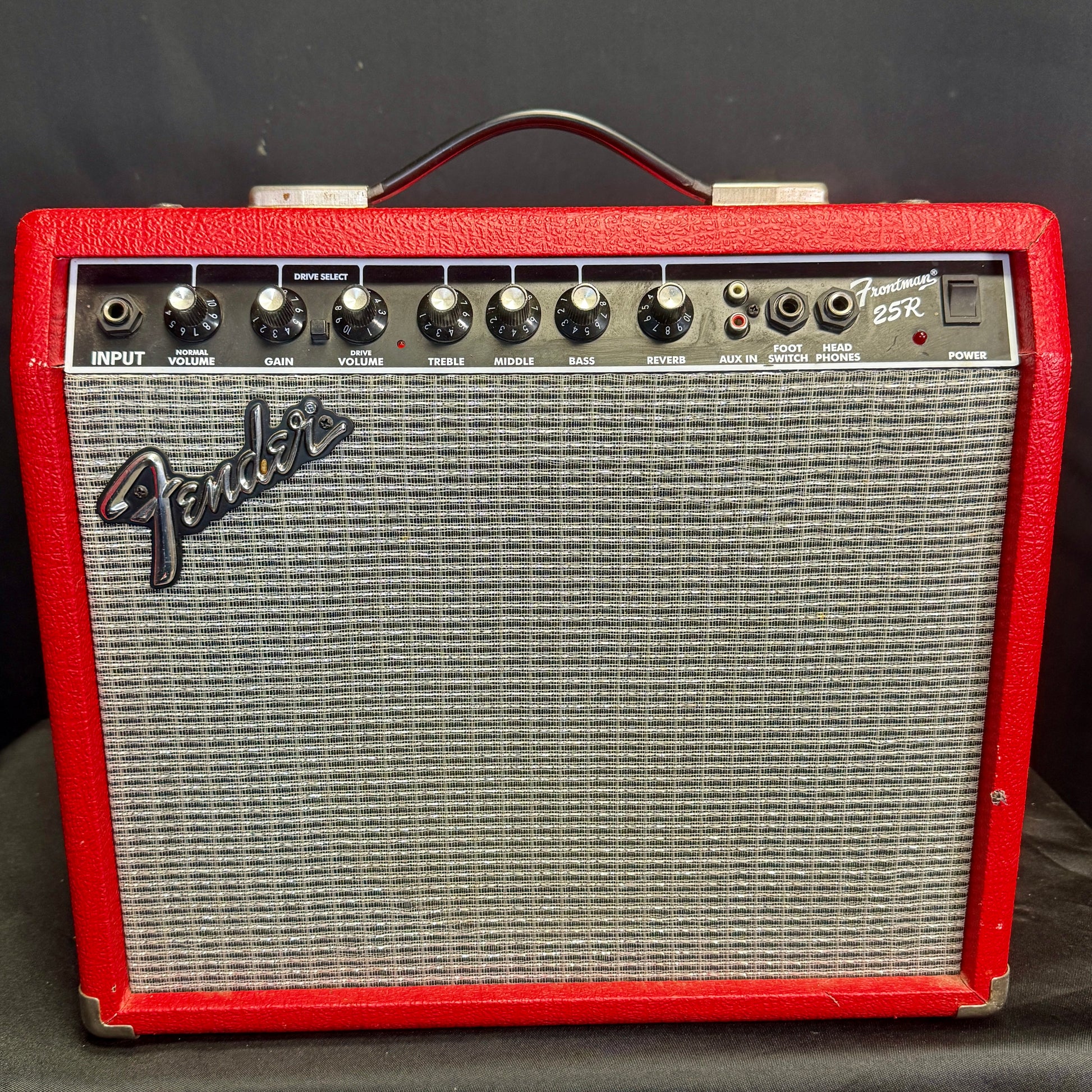 Fender guitar amplifier with red casing on a black background