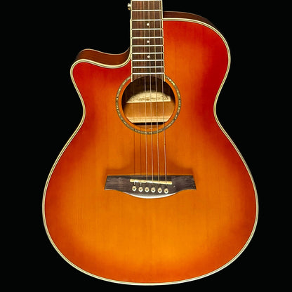 Acoustic guitar with a sunburst finish on a dark background