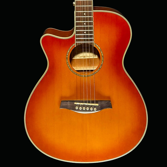 Acoustic guitar with a sunburst finish on a dark background