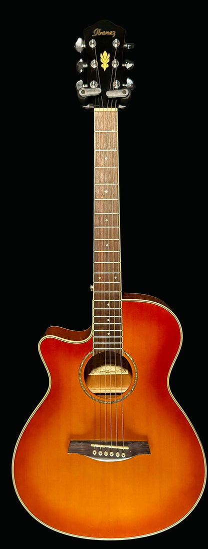 Acoustic guitar with a sunburst finish on a black background
