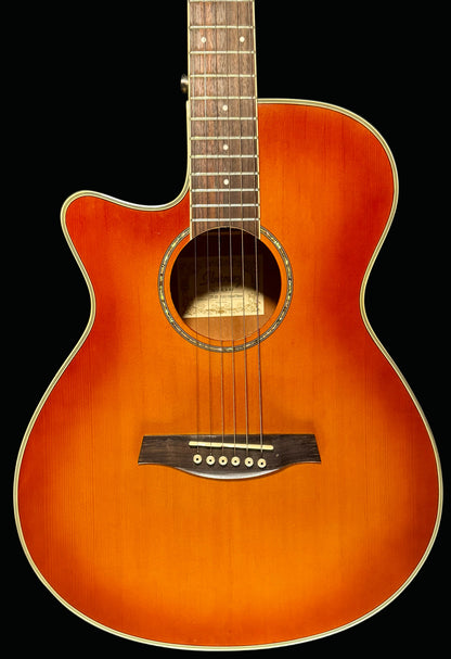 Acoustic guitar with a sunburst finish on a dark background