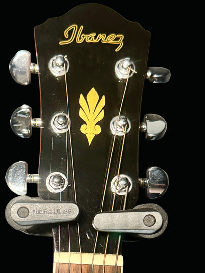 Ibanez guitar headstock with tuning pegs and logo on a gray background