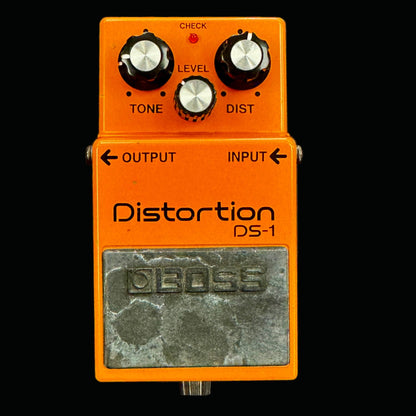 Orange distortion pedal with 'BOSS' branding on a gray background