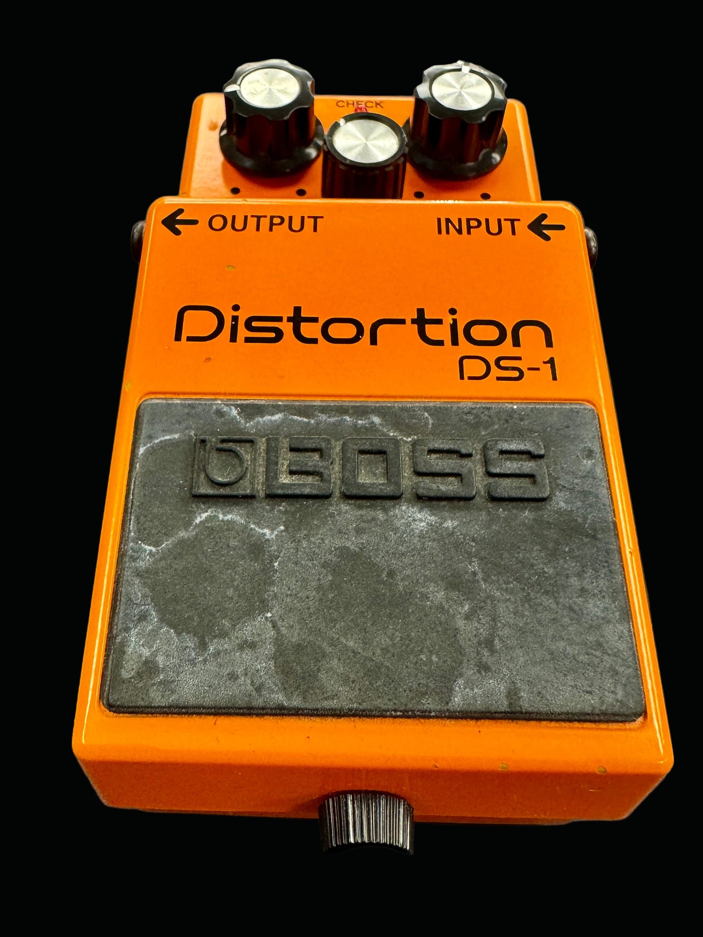 Orange Boss DS-1 distortion pedal on a gray background