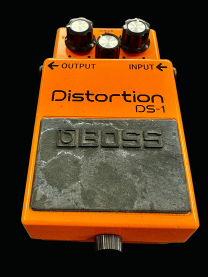 Orange Boss DS-1 distortion pedal on a gray background