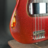 Lower detail of Used 2013 Fender Custom Shop '64 Precision Bass Relic Red Sparkle over Sunburst.
