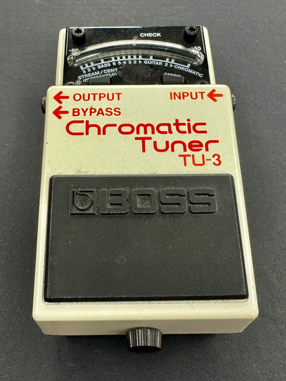 Boss TU-3 Chromatic Tuner pedal on a dark background