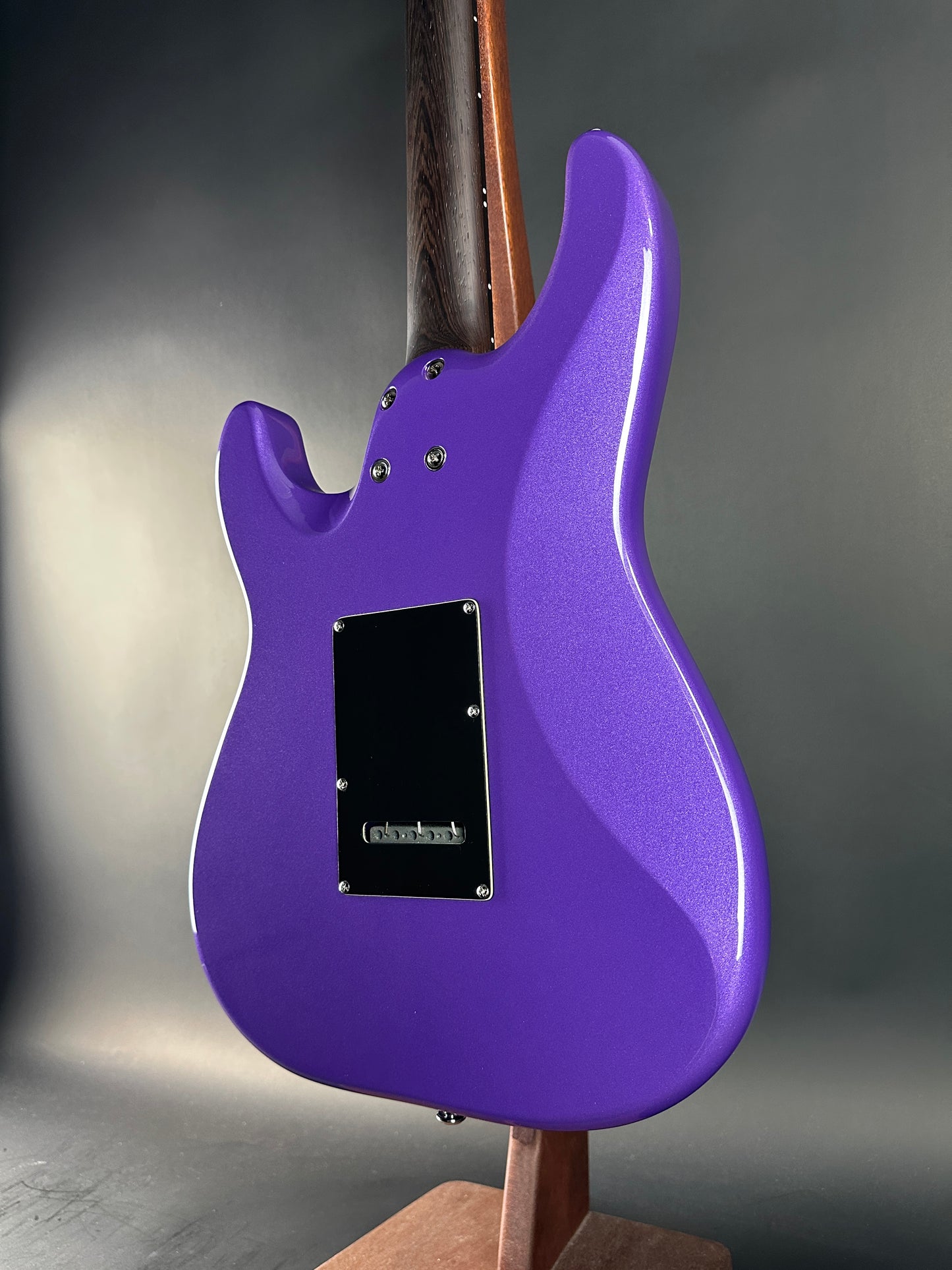 Purple electric guitar body on a gray background