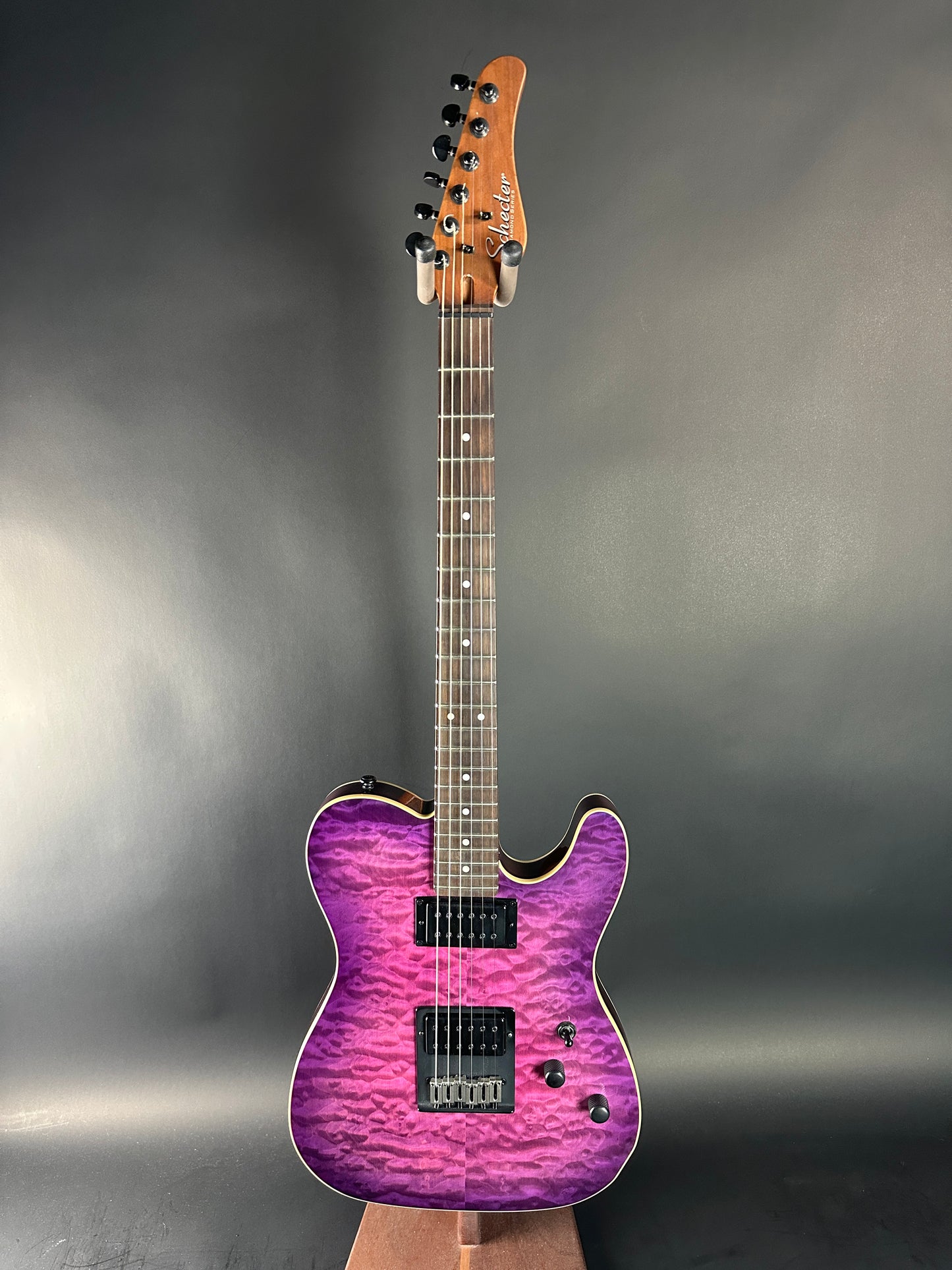 Electric guitar with a purple finish on a gray background