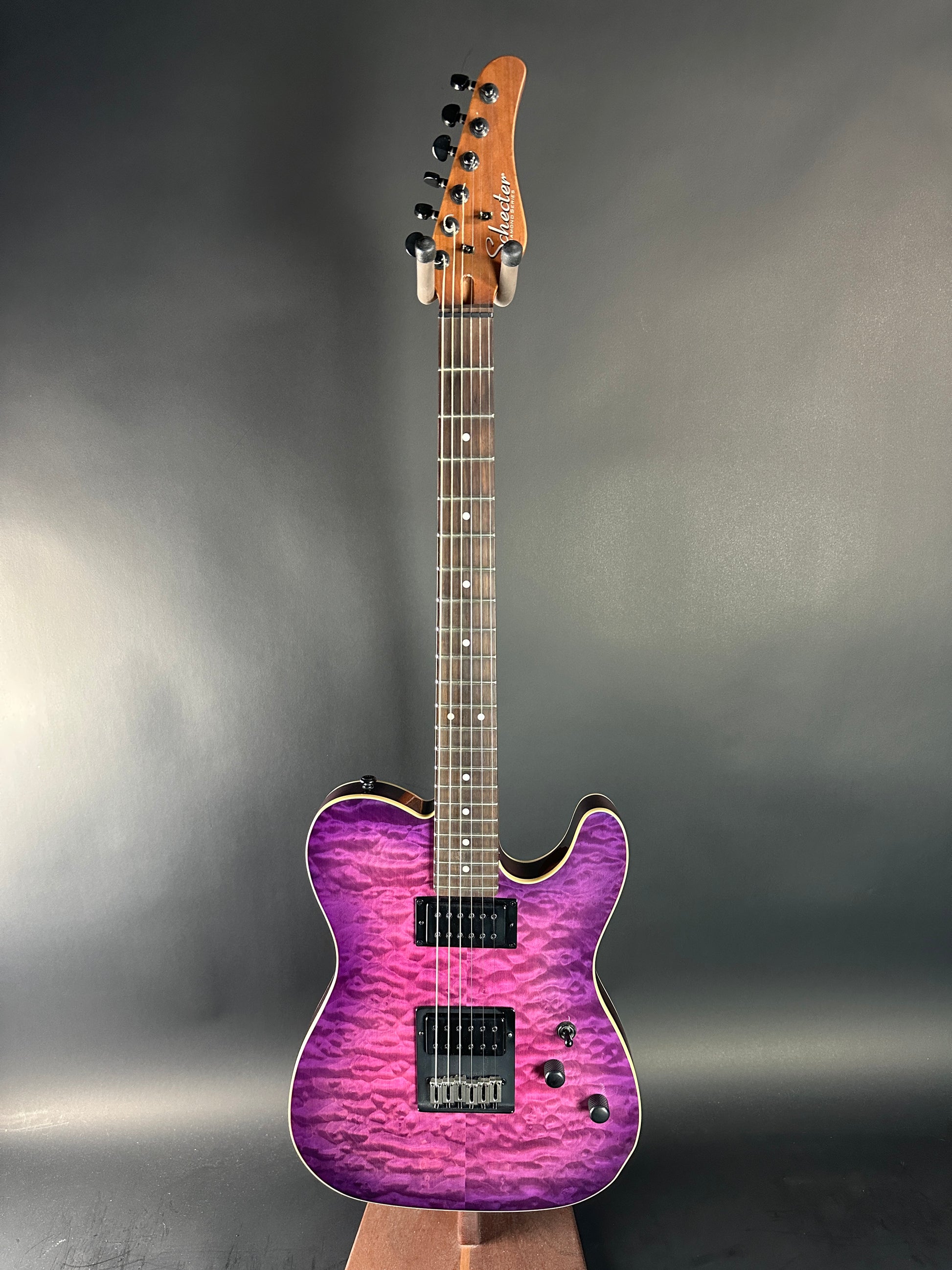 Electric guitar with a purple finish on a gray background