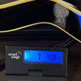 Used 2018 Gretsch G5420TG Electromatic Black on scale displaying weight.