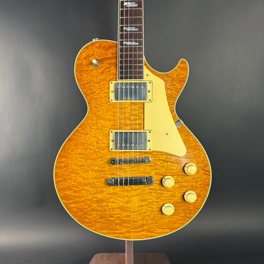 Electric guitar with a sunburst finish on a dark gray background