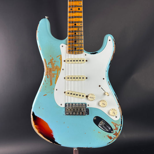 Worn blue electric guitar on a dark background