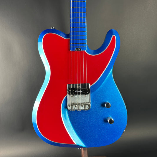 Blue and red electric guitar on a gray background
