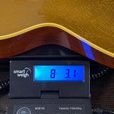 Used Collings CL City Limits Aged Goldtop on scale.