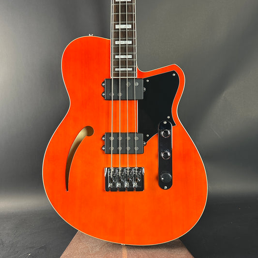 Orange electric guitar on a gray background
