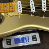 Used 2014 Squire Classic Vibe 60th Anniversary Strat on scale displaying weight.