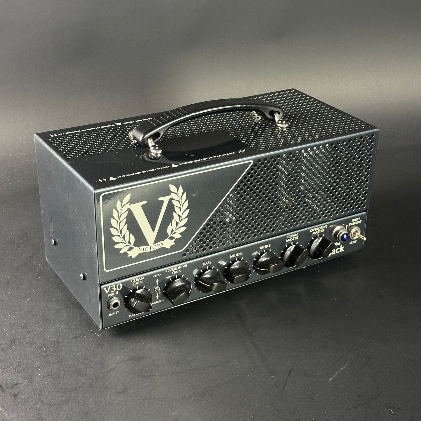 Guitar amplifier head with 'V' logo on a gray background