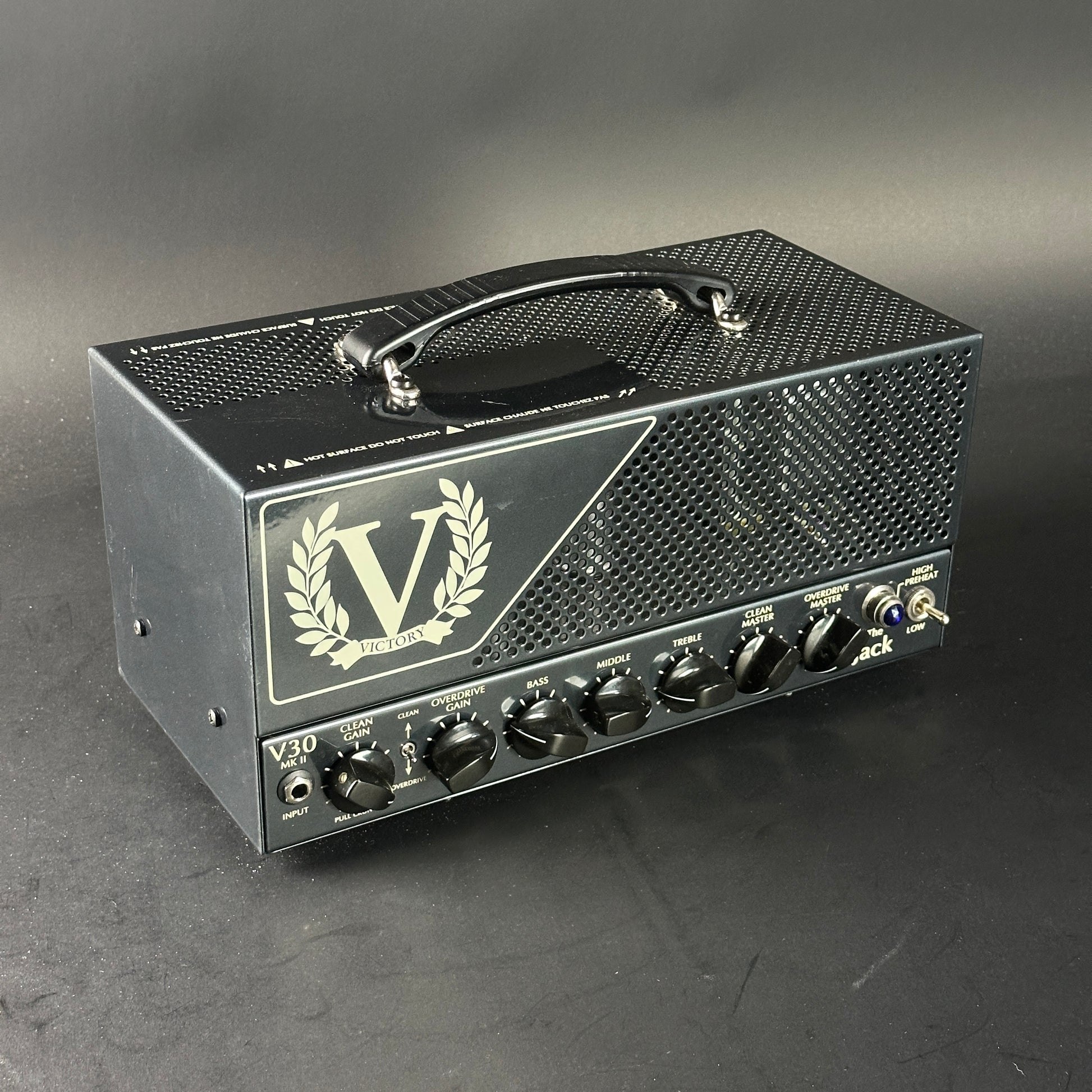 Guitar amplifier head with 'V' logo on a gray background