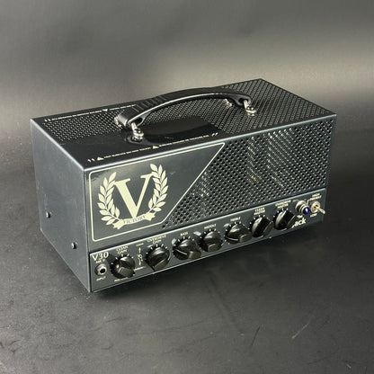 Guitar amplifier head with 'V' logo on a gray background