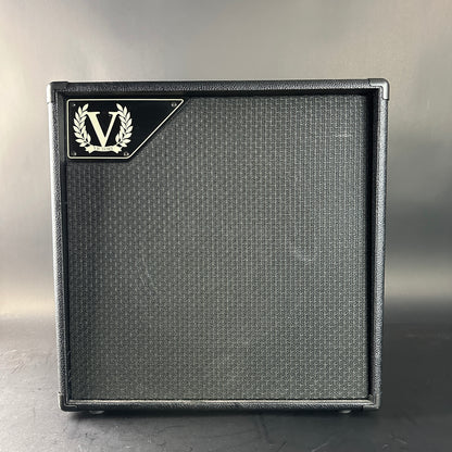 Guitar amplifier cabinet with a brand logo on a gray background
