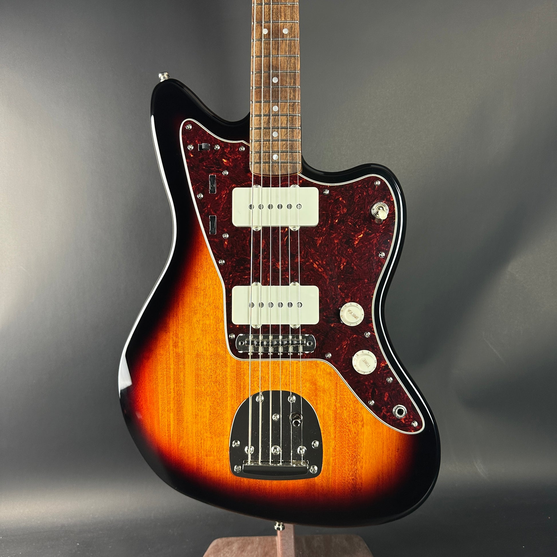 Electric guitar with a sunburst finish on a gray background