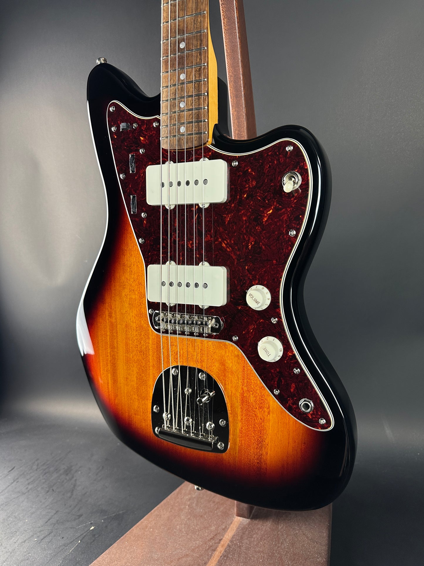 Fender electric guitar with a sunburst finish on a dark background