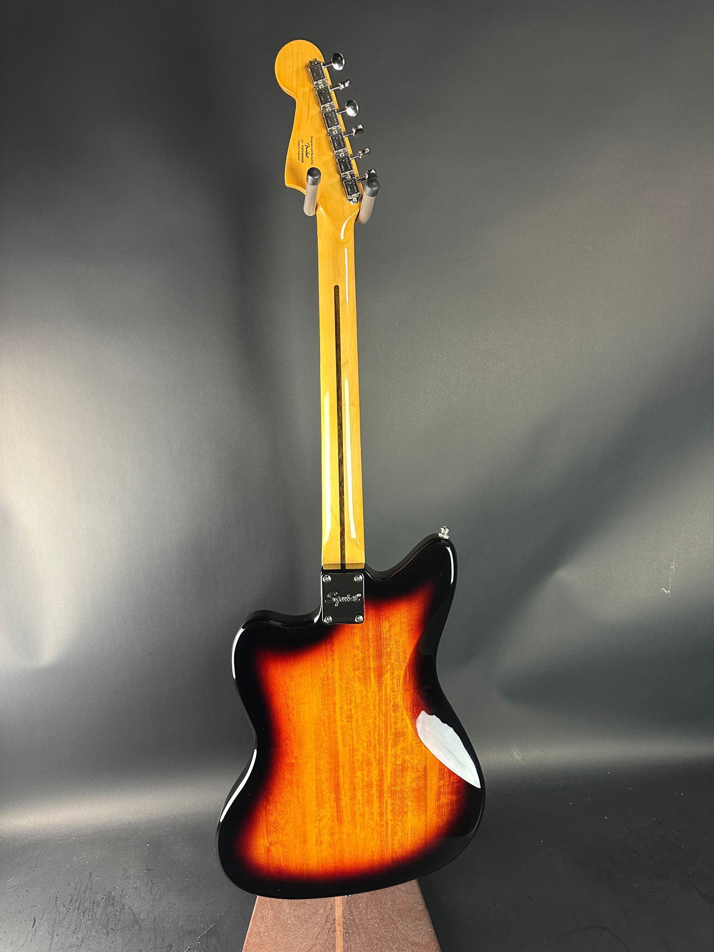 Fender electric guitar with sunburst finish on a gray background