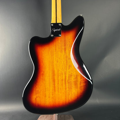 Electric guitar with sunburst finish on a gray background