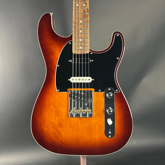 Electric guitar with a sunburst finish on a gray background