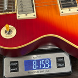 Used 2021 Epiphone Les Paul Limited 1959 Cherry Burst on scale displaying weight.