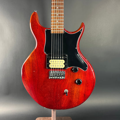 Red electric guitar on a gray background